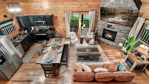 A cozy cabin interior with a kitchen, dining area, and living room. - Spring Break Retreat: Gorgeous Views, Sauna & Spa (Sevierville)