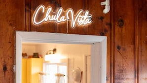 A neon sign reading "Chula Vista" above a doorway. - Incredible Views! Historic Branson Home, two Porch Swings (Branson)