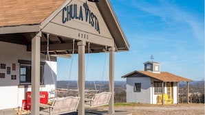 A Chula Vista building with a swing area and a small adjacent structure. - Incredible Views! Historic Branson Home, two Porch Swings (Branson)