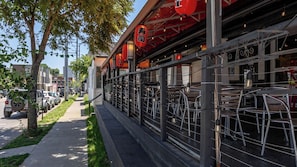 A restaurant with outdoor seating, a sidewalk, and parked cars. - The Nomad 4 Studio Buyout 16 Guests in Hillsboro (Nashville)