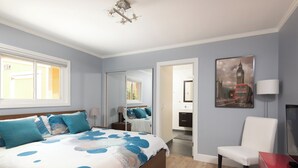 A bedroom with a bed, a chair, a desk, and a painting. - La Jolla Kid Friendly Beach House (San Diego)