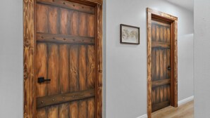 Two wooden doors with metal studs and a black handle. - Pirates Cove: Heated Pool, Arcades, Playground and more! (Garden Grove)
