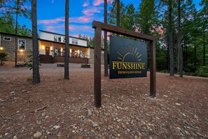 A sign for 'FUNSHINE 359 BOULEDER RIDGE' with a stone building in the background. - 8 Bedroom W/Pool, Playset, Putt-Putt, Game Room, ATV Access (Broken Bow)