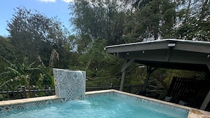 A rectangular swimming pool with clear blue water, surrounded by a tiled edge and a stone border. - Casa Camino Buyé, 6 bedrooms, Private Pool (Cabo Rojo)