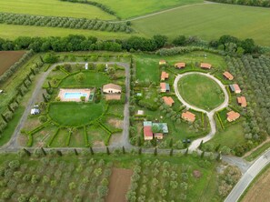 An aerial view of a property with a swimming pool, multiple buildings, and well-maintained gardens. - Bungalow 'Stella 1' with Shared Pool, Private Terrace and Air Conditioning (Bibbona)