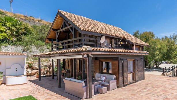 A two-story house with a patio area, a wooden deck, and a covered seating area. - Holiday Home 'La Haima' with Sea Views, Wi-Fi and Air Conditioning (Motril)