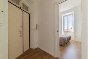 A room with a bed, a wardrobe, and a window.