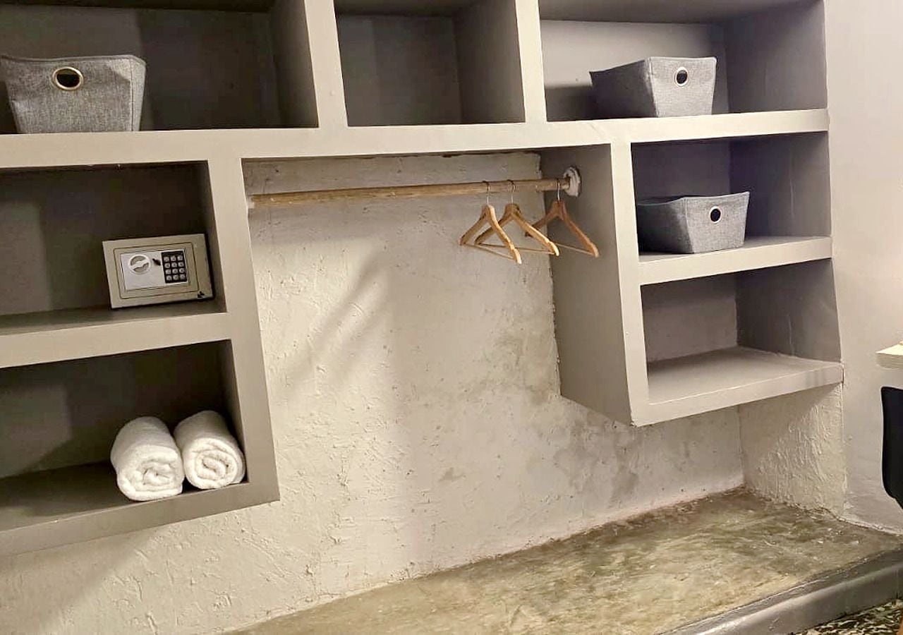 A storage area with shelves, a hanging rack, and a security keypad.