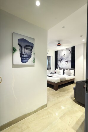 A modern bedroom with a large bed, a ceiling fan, and a marble floor. - Myotel - Santacruz (Mumbai)