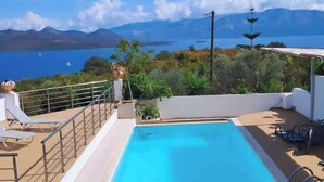 A rooftop pool with lounge chairs, a view of a lake, and mountains in the background. - Luxury Villa- Sleeps 6 - Views, Pool, Hot Tub (Nikiana)