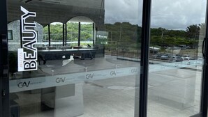 A modern hotel interior with a glass facade, a visible outdoor area with greenery, and a sign for 'Harmony Salus Cay'. - Beachfront resort Muro Alto/Porto de Galinhas, smart apartment with pool, 4-star (Ipojuca)