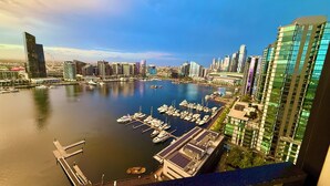 A marina with boats docked, surrounded by modern high-rise buildings. - Yarra Accommodation  (Melbourne)