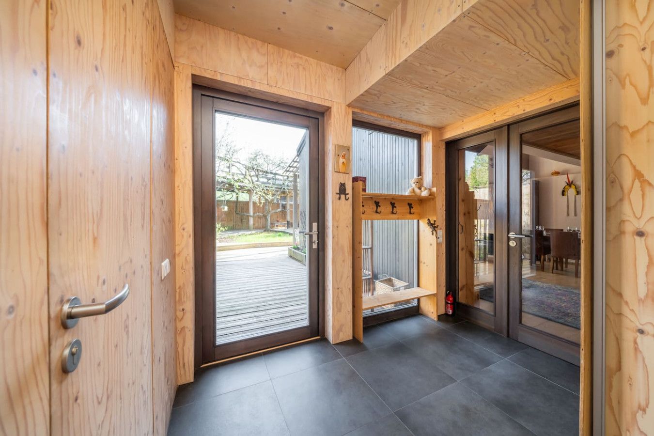 A wooden interior with a sliding glass door leading to an outdoor area.