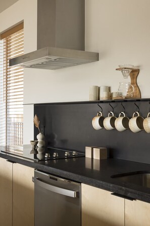 Fridge, dishwasher, coffee/tea maker, cookware/dishes/utensils