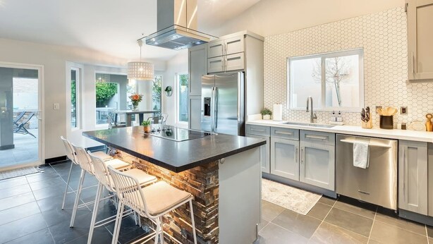 A modern kitchen with a central island, stainless steel appliances, and a view to the outdoors. - Meadow Hills in North Scottsdale / Heated Pool (Scottsdale)