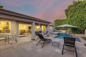 A patio area with a pool, outdoor seating, and a view of the kitchen. - Meadow Hills in North Scottsdale / Heated Pool (Scottsdale)