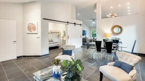 A modern living room with a sofa, chairs, a coffee table, and a dining area with a table and chairs. - Meadow Hills in North Scottsdale / Heated Pool (Scottsdale)