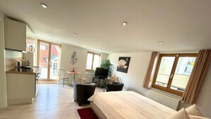 A modern bedroom with a bed, a desk, and a chair.