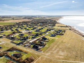 An aerial view of a residential area with houses, roads, and a body of water. - "Nikolce" - 300m to the fjord by Interhome (Vinderup)