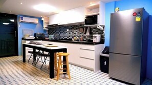 Full-size fridge, microwave, cookware/dishes/utensils