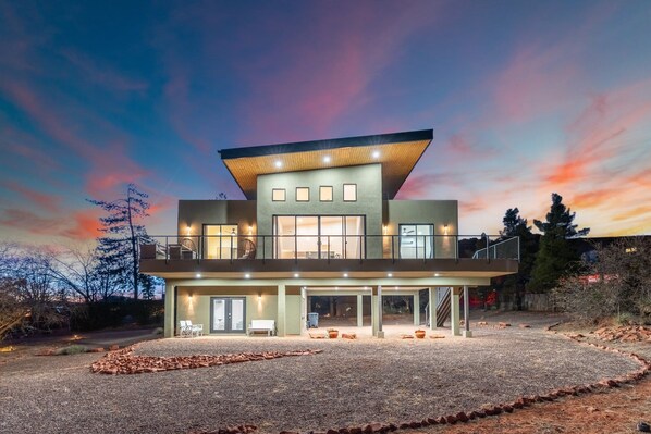 A modern two-story house with a flat roof, large windows, and a covered patio area. - NEW|Moondance Redrock View Terrace|Mtn. Views (Sedona)