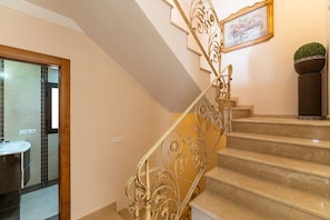 A staircase with ornate metal railings leading to a landing. - Villa Miguel Franco (Nerja)