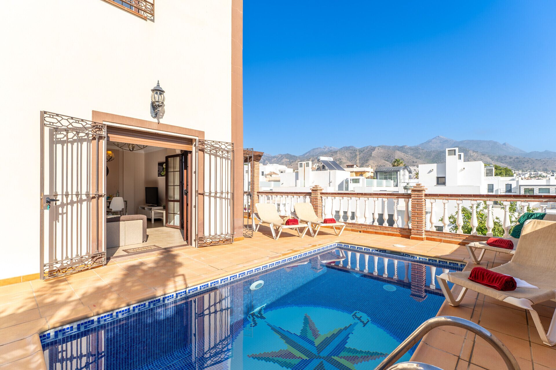 A rooftop pool with a clear view of mountains in the background.