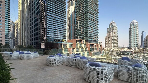A rooftop terrace with outdoor seating and a marina view. - Maison Privee - Sleek Stay in Dubai Marina’s Famous Twisting Tower  (Dubai)