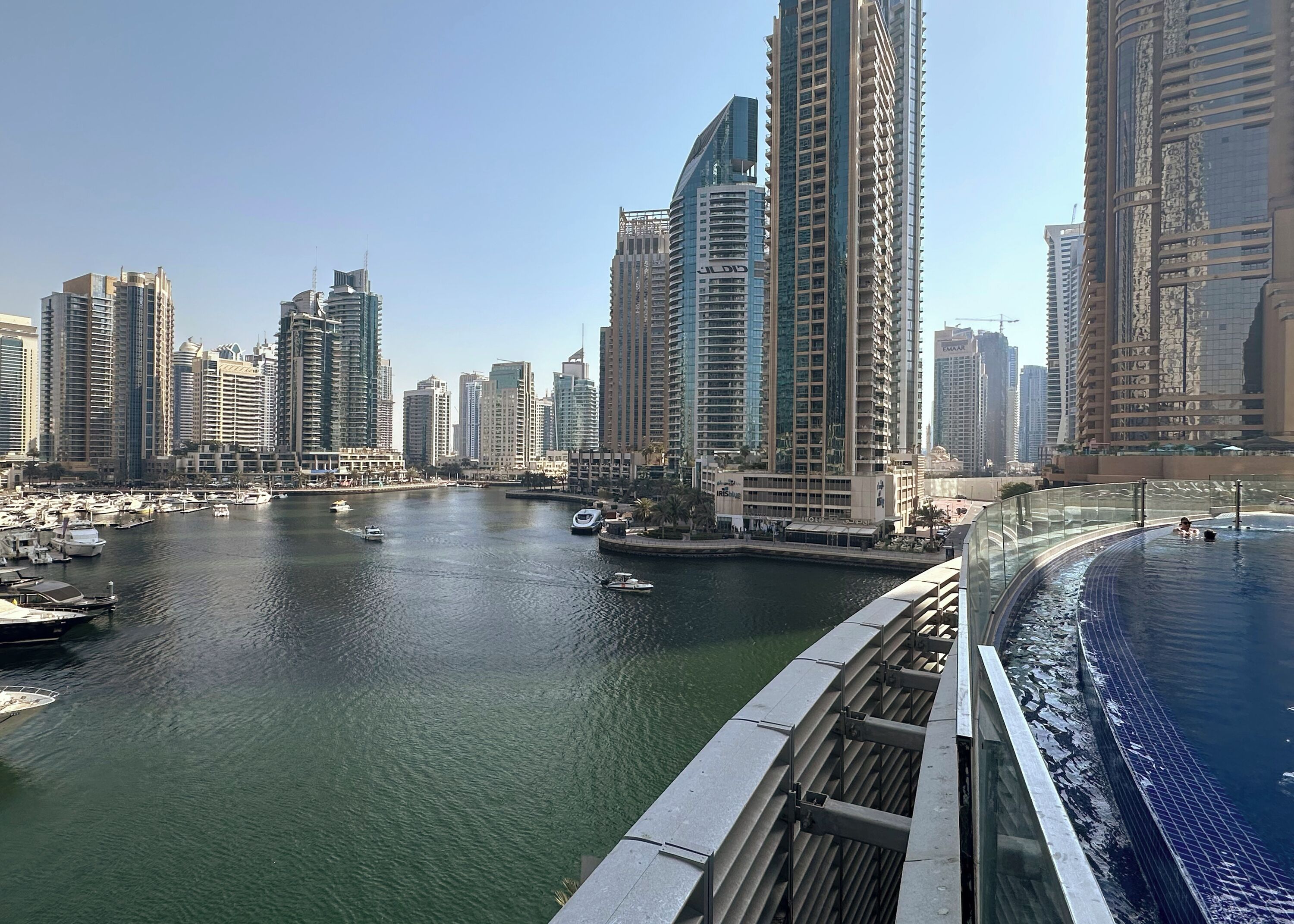 A marina with boats and high-rise buildings in the background.