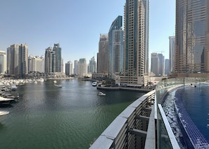A marina with boats and high-rise buildings in the background.