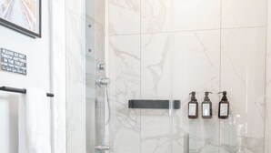 A modern bathroom with a glass-enclosed shower, a toilet, and a sink. - Trendy Brickell 2bd/2bth Free Parking Apt 5 (Miami)