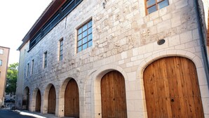 Un edificio de piedra con arcos y una puerta de madera.