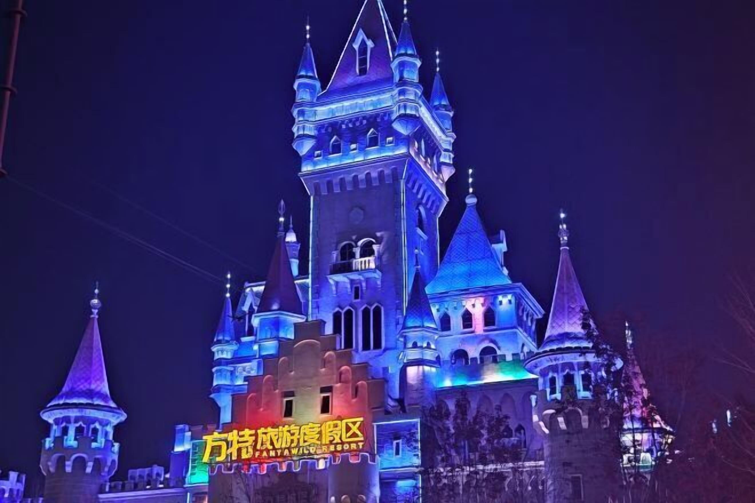 A castle-like building with multiple towers and a sign in a foreign language.