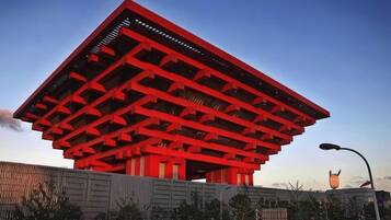 A large red building with a flat roof and multiple levels.