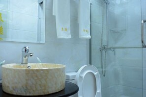 A bathroom with a marble sink, a toilet, and a glass-enclosed shower. - Chenxiang Fashion Hostel (Shanghai)