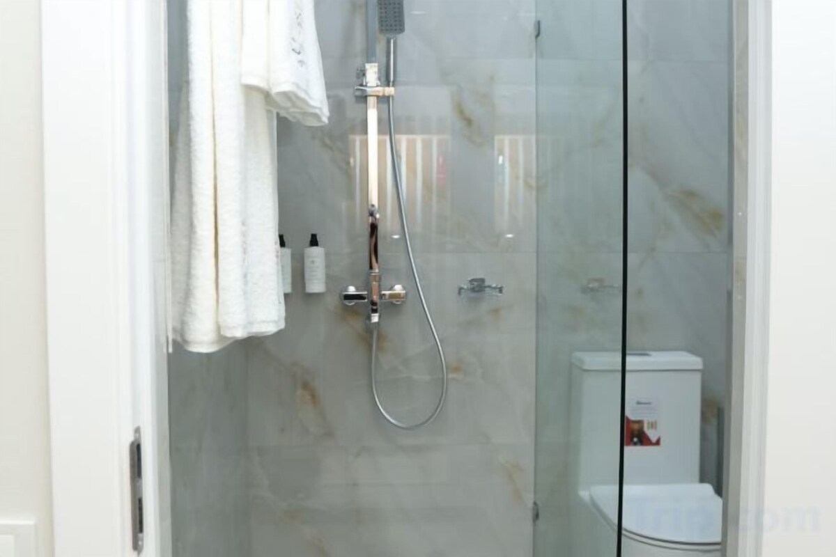 Shower, hair dryer, slippers, towels
