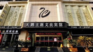 A hotel entrance with a large number '70' sign, a sign for 'TIAN E Hotel', and a sign for 'Tianqing Hotel'. - Swan Theme Culture Hotel (Zhengzhou Railway Station East Plaza Branch) (Zhengzhou)