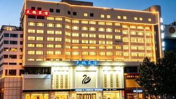 A multi-story hotel with a prominent entrance and signage.