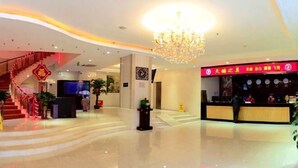 A hotel lobby with a grand staircase, a reception desk, and a chandelier. - Swan Theme Culture Hotel (Zhengzhou Railway Station East Plaza Branch) (Zhengzhou)
