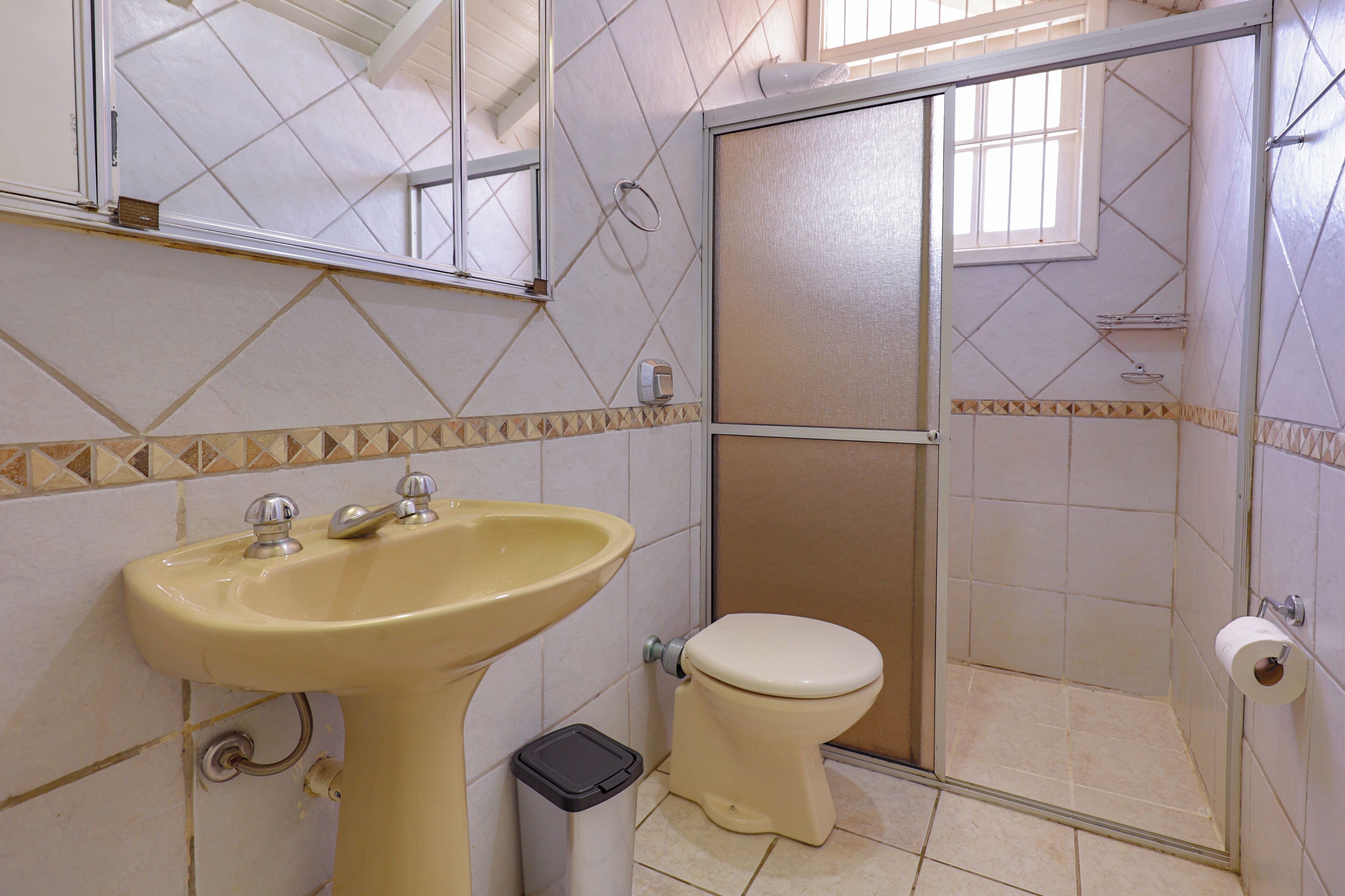 A bathroom with a sink, toilet, and shower.