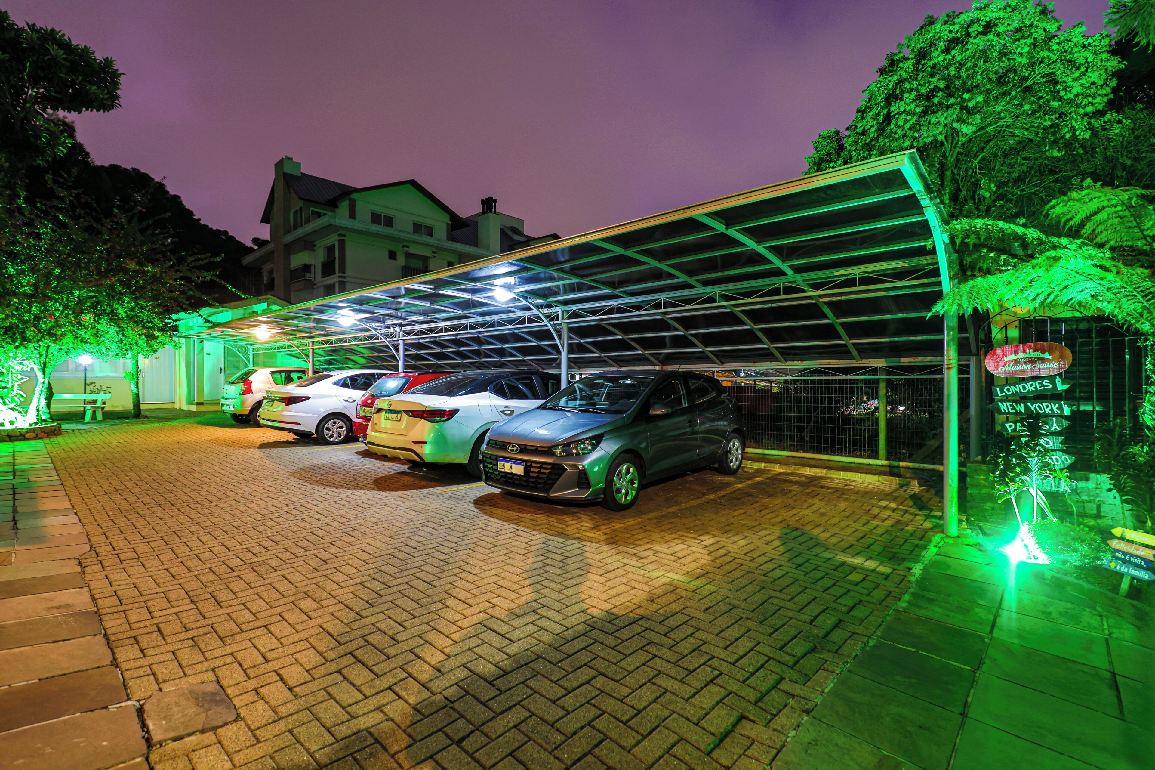 A parking area with a covered structure and a sign indicating a location in London, New York.