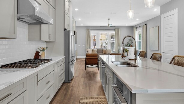 A modern kitchen with a central island, stainless steel appliances, and a view into the living area. - Inlet Beach Retreat with Rooftop Views, 4 Bikes + Free Attraction Tickets! (Inlet Beach)