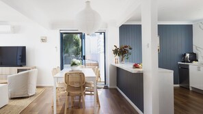 Enjoy meals in the spacious dining area with a large table and comfortable seating for four.