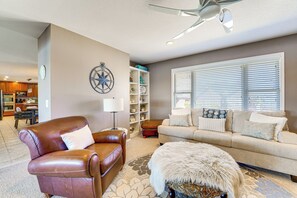 A living room with a brown leather sofa, a beige sofa, and a patterned rug. - The Best Views on Beaver Lake! Home w/ Deck & BBQ (Rogers)