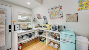 A compact kitchen with a sink, microwave, and vintage refrigerator, along with various kitchen utensils and appliances. - 7 Mi to Tyler State Park: 'a-game' Cabin (Tyler)