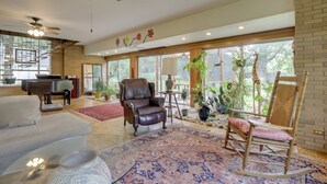A spacious living room with a piano, leather armchair, and rocking chair. - Spacious & Updated Farmhouse in Yellow Springs (Yellow Springs)
