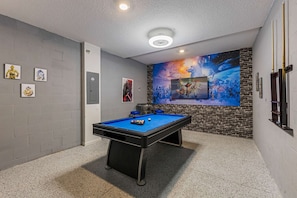 - Step into a game room designed for fun, featuring a sleek pool table and themed decor
- Challenge friends to a round of pool or kick back and enjoy the entertainment setup
- A perfect space to unwind, play, and create unforgettable memories - Kissimmee Retreat: Cozy 2BR Condo near Theme Parks (Kissimmee)