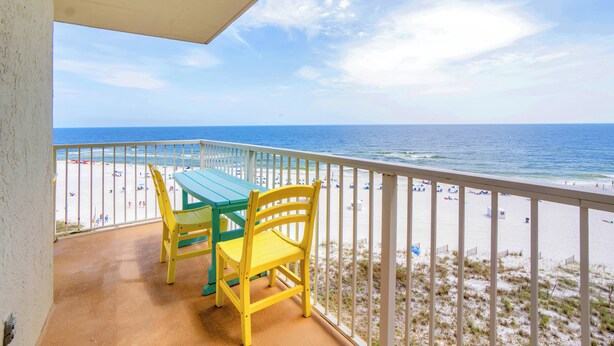 A balcony with a table and chairs overlooking a beach. - Seaside Beach & Racquet 4707 by Liquid Life (Orange Beach)