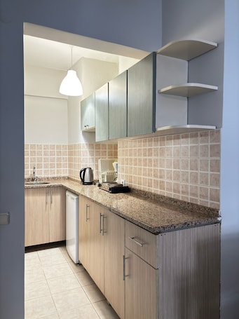 Mini-fridge, stovetop, coffee/tea maker, cookware/dishes/utensils
