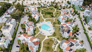 A resort with multiple buildings, a central pool, and a beach. - Playa Turquesa D403_80Mbps_Private Beach Access_Pools (Bavaro-Punta Cana)